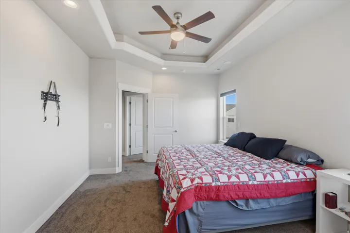 Recessed lighting illuminating a tray ceiling with a ceiling fan