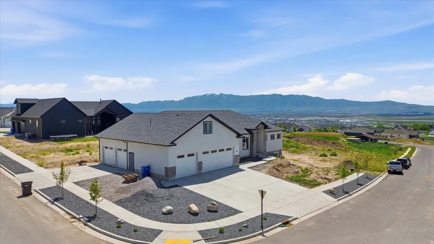 Corner lot.   Lots of parking.   Modern single-story residence with a white stucco exterior and stone accents