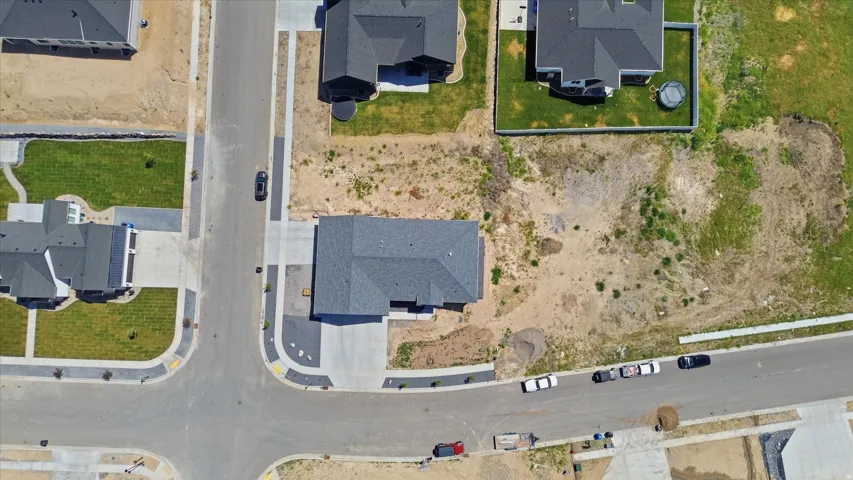 New construction home featuring a dark gray shingle roof and a concrete driveway