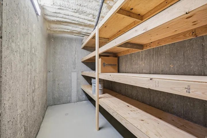 Utility room with concrete walls and a painted floor