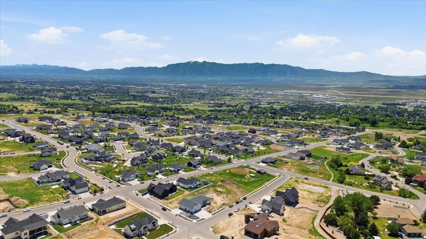 Aerial perspective showcasing a residential community with mature landscaping and mountain scenery