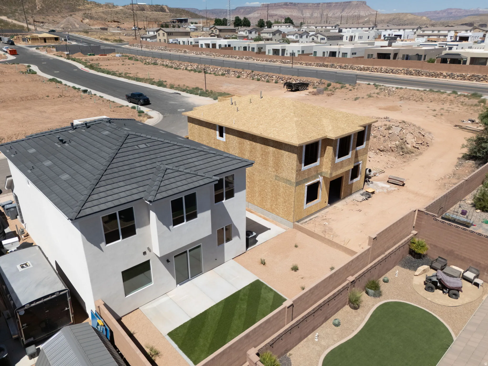 White stucco exterior featuring a dark gray tile roof