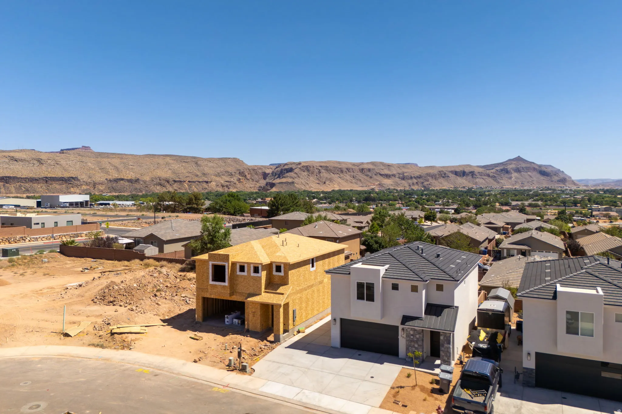 New construction property featuring a stucco exterior and a dark tile roof