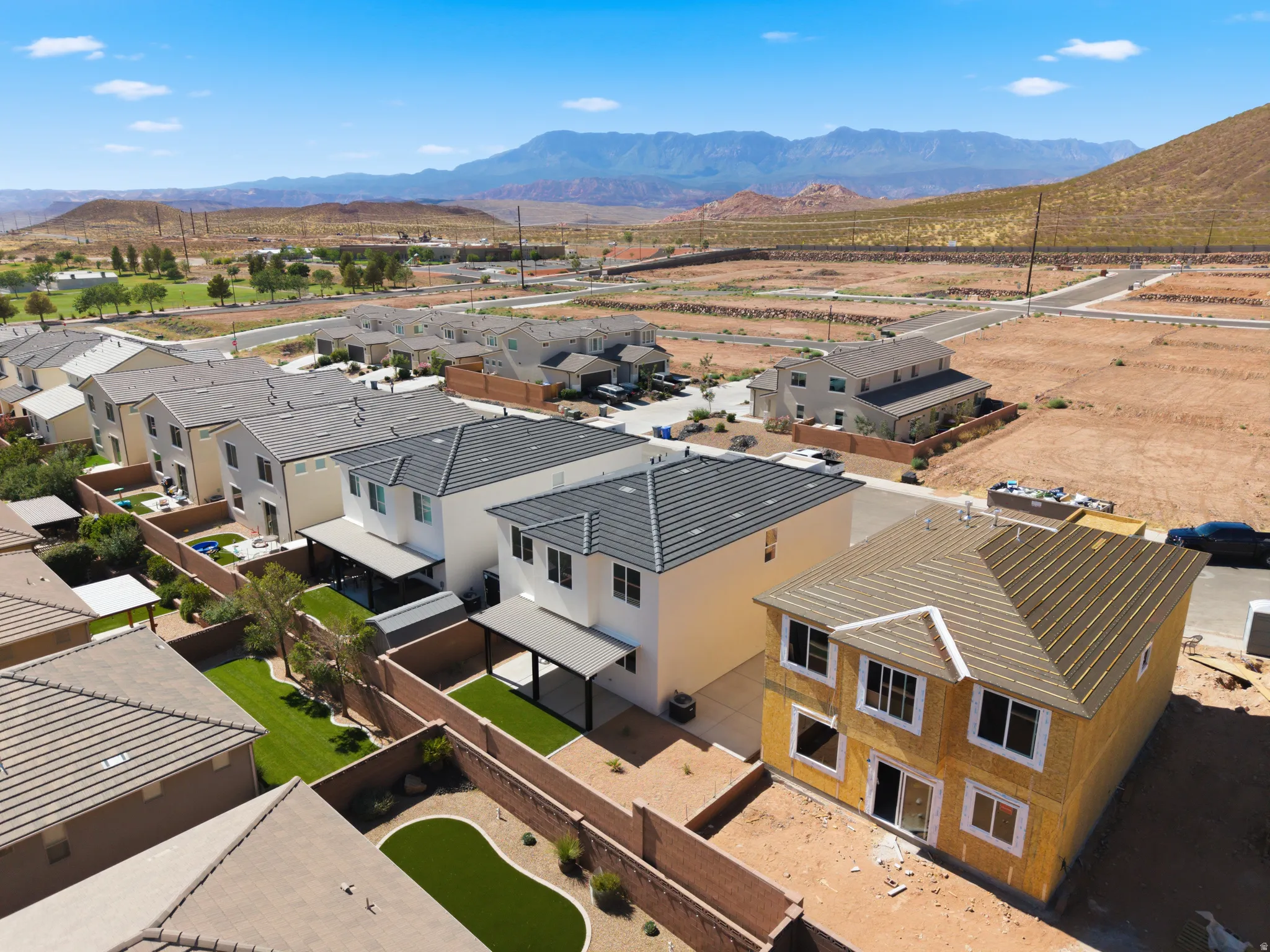 Newly constructed two-story residence featuring a hip roof and exposed sheathing