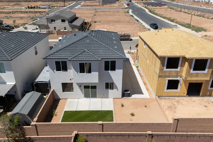 Contemporary two-story stucco exterior featuring a dark tile roof