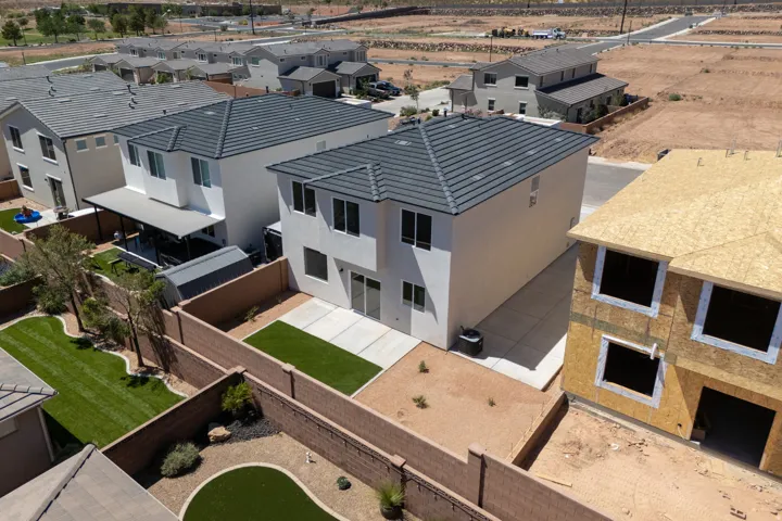 Modern stucco exterior with dark tile roofing
