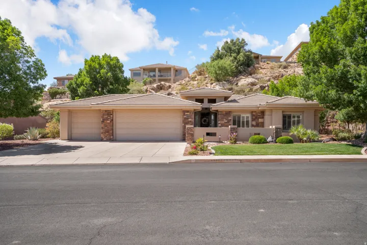 Contemporary stucco exterior with stone accents and a two-car garage