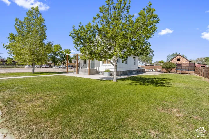 Expansive green lawn with mature shade trees