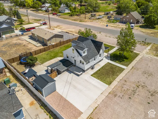 White siding residence with a dark shingle roof and dormer windows