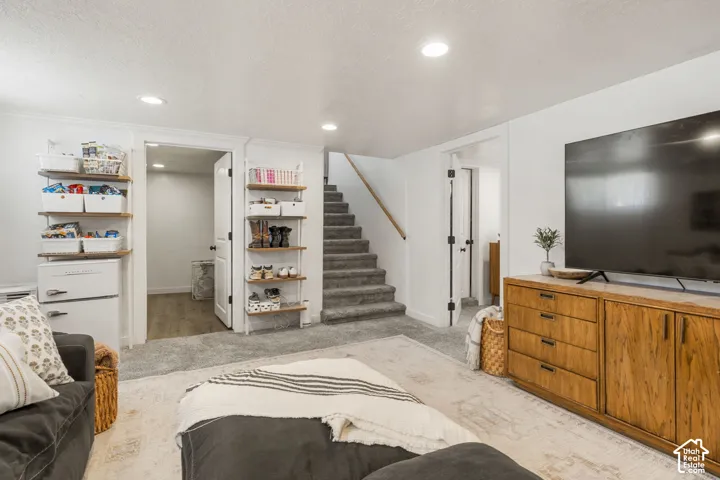 Spacious entertainment room featuring recessed lighting, plush carpeting.