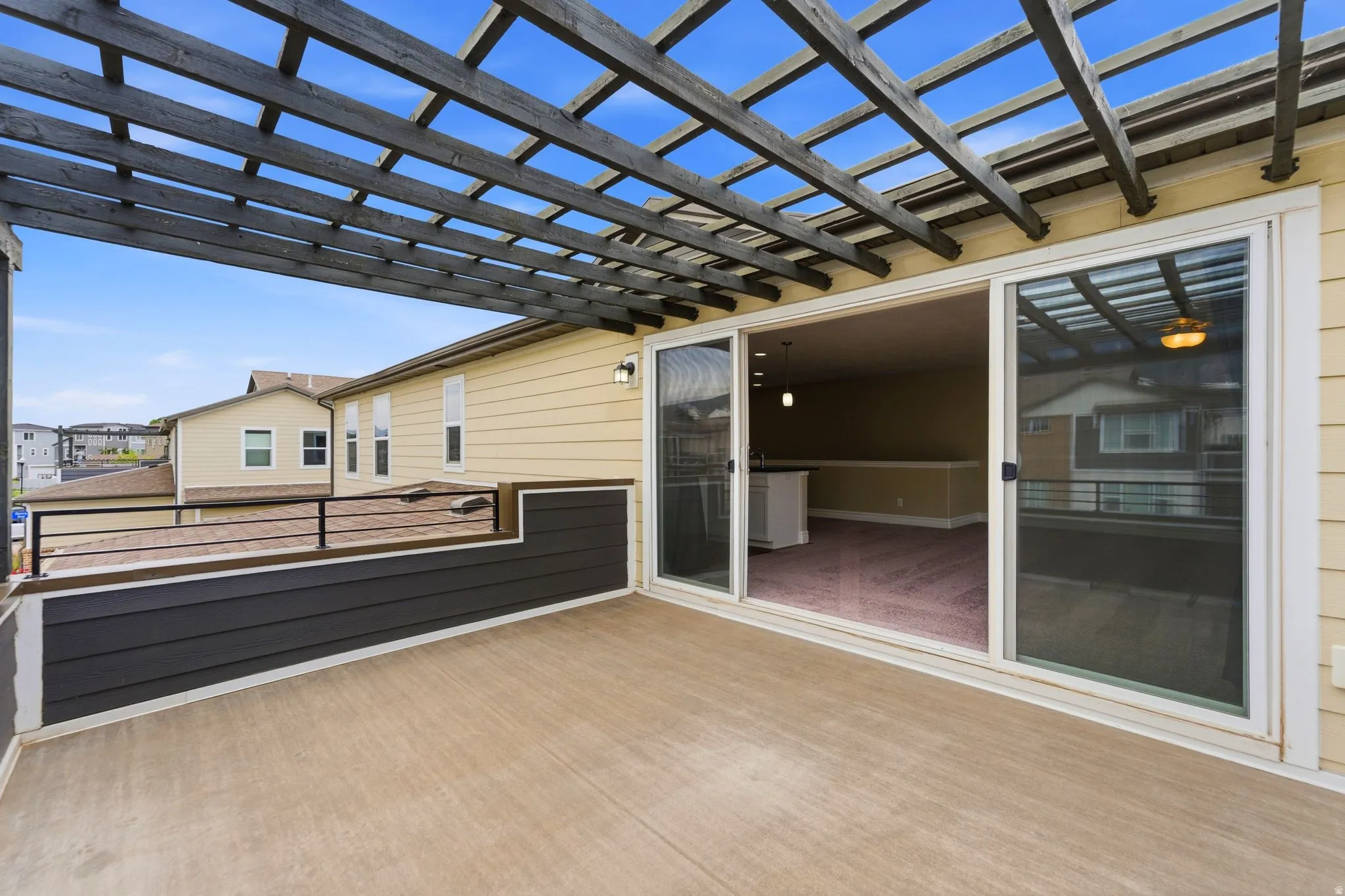 Outdoor deck featuring a dark wood pergola and composite decking
