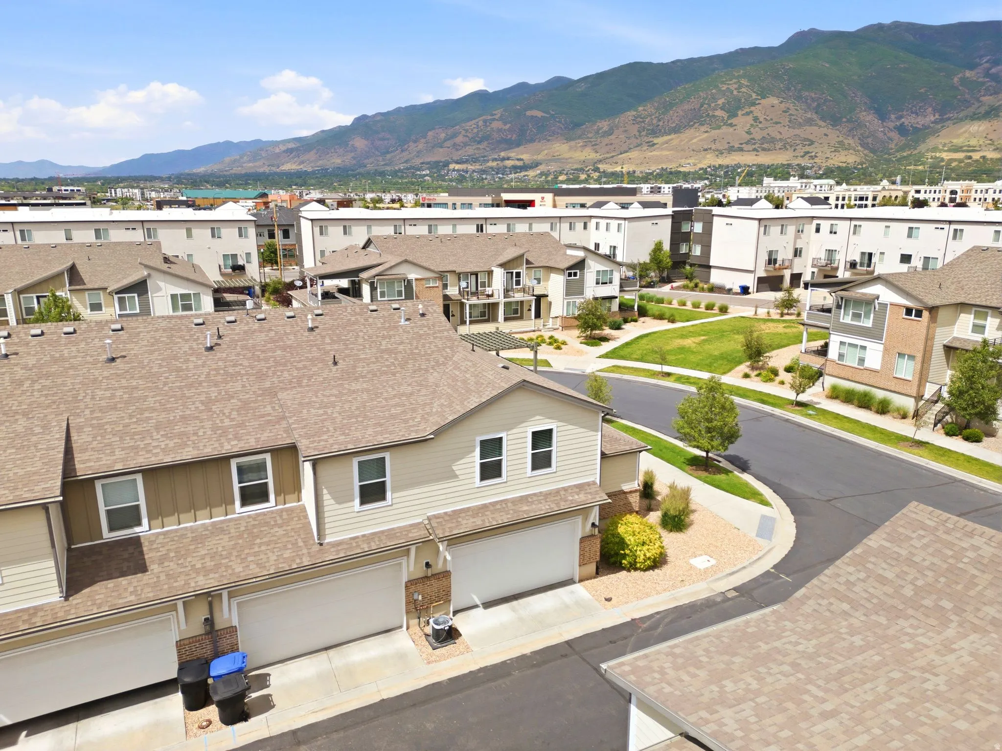 Residential community featuring townhomes with attached garages and shingle roofs