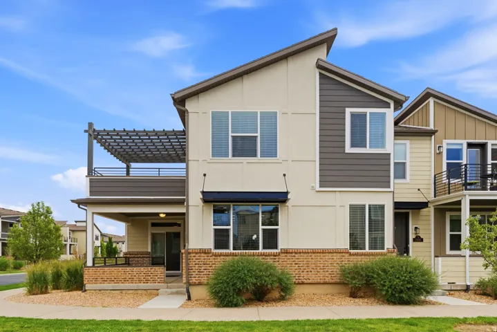 Contemporary multi-level exterior featuring light-colored siding with dark gray accents