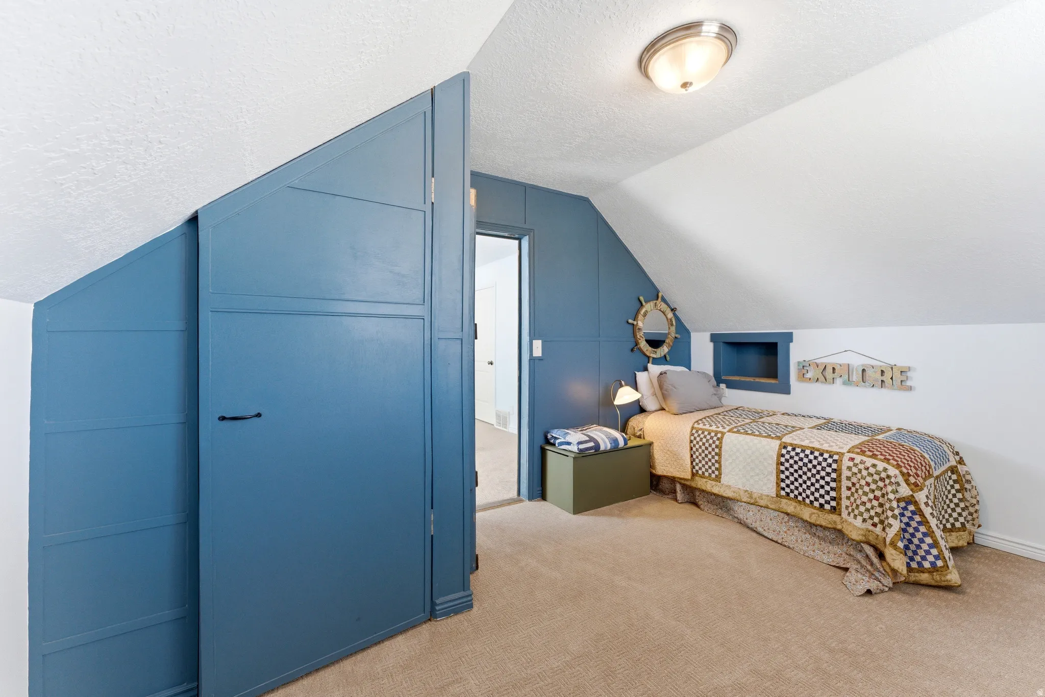 Room with sloped ceilings and built-in storage