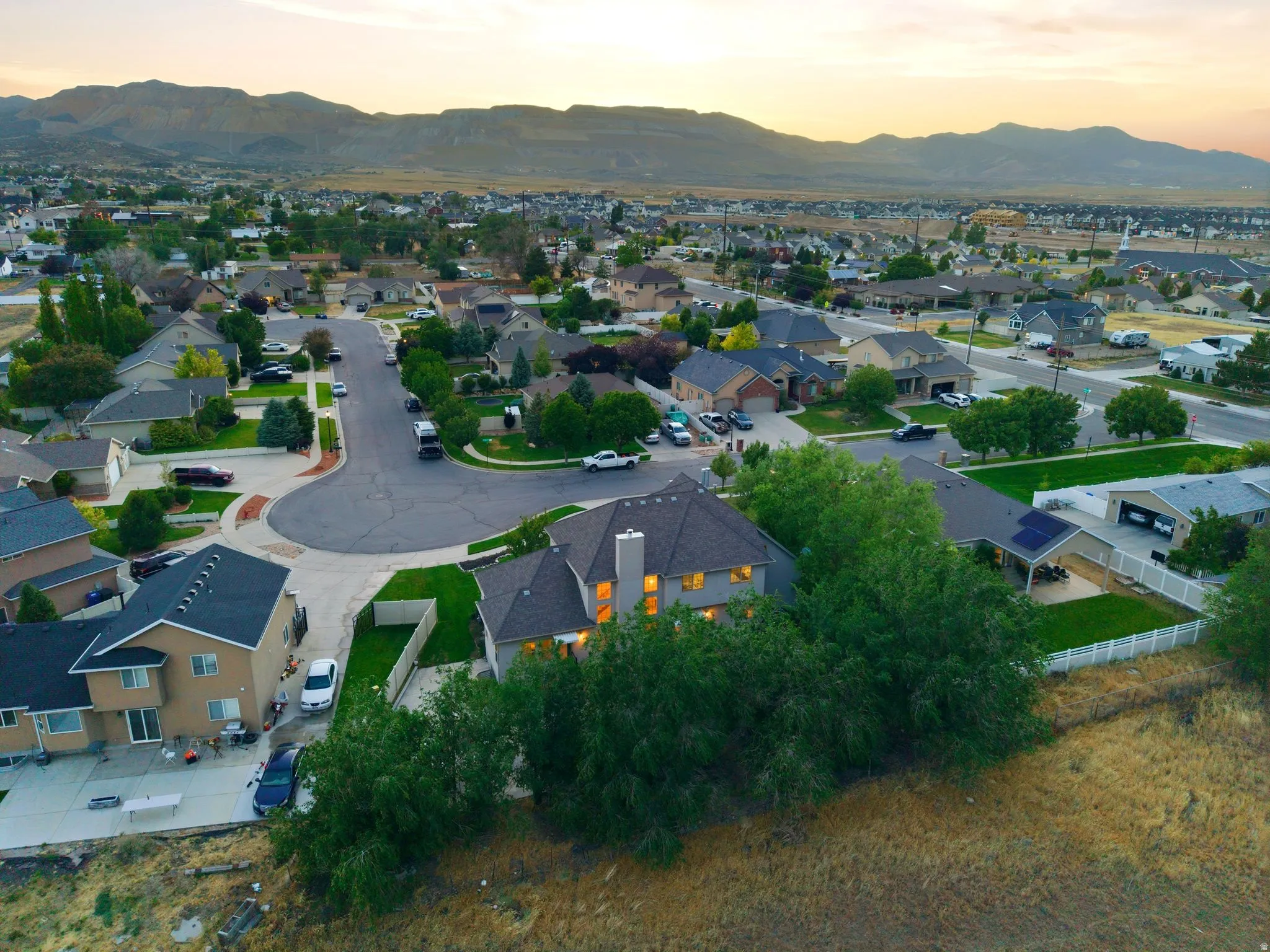 Aerial perspective showcasing a residential neighborhood with distant mountain ranges