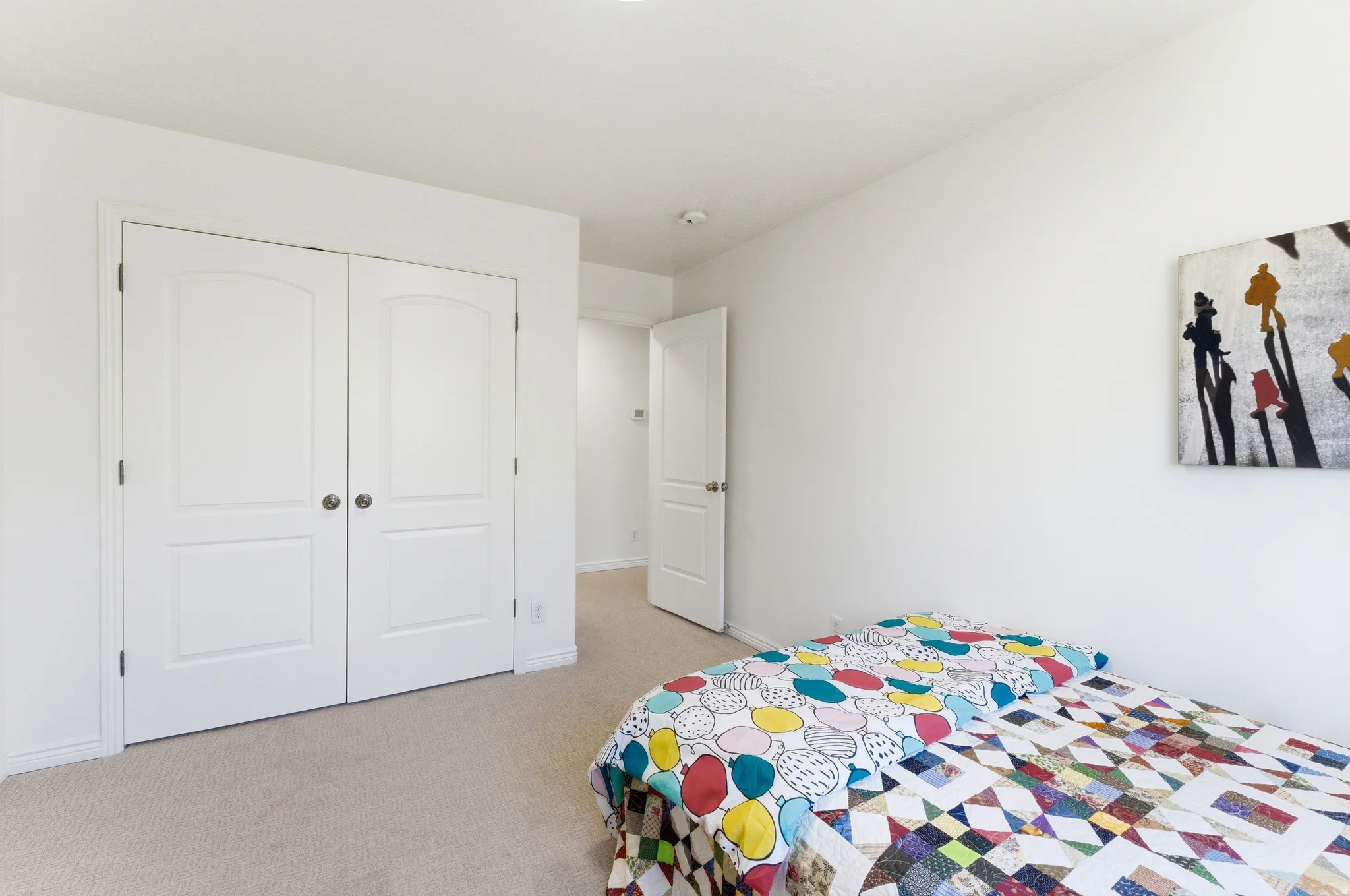Recessed lighting illuminates neutral carpeting and light-toned walls