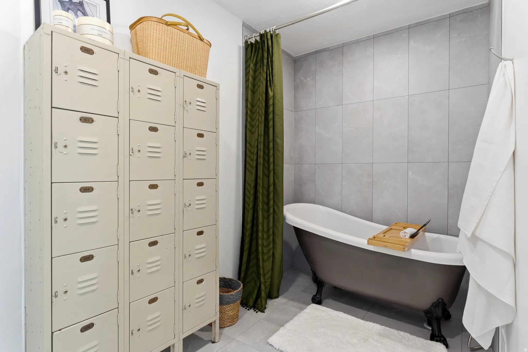 Freestanding clawfoot tub with a dark exterior finish and light interior