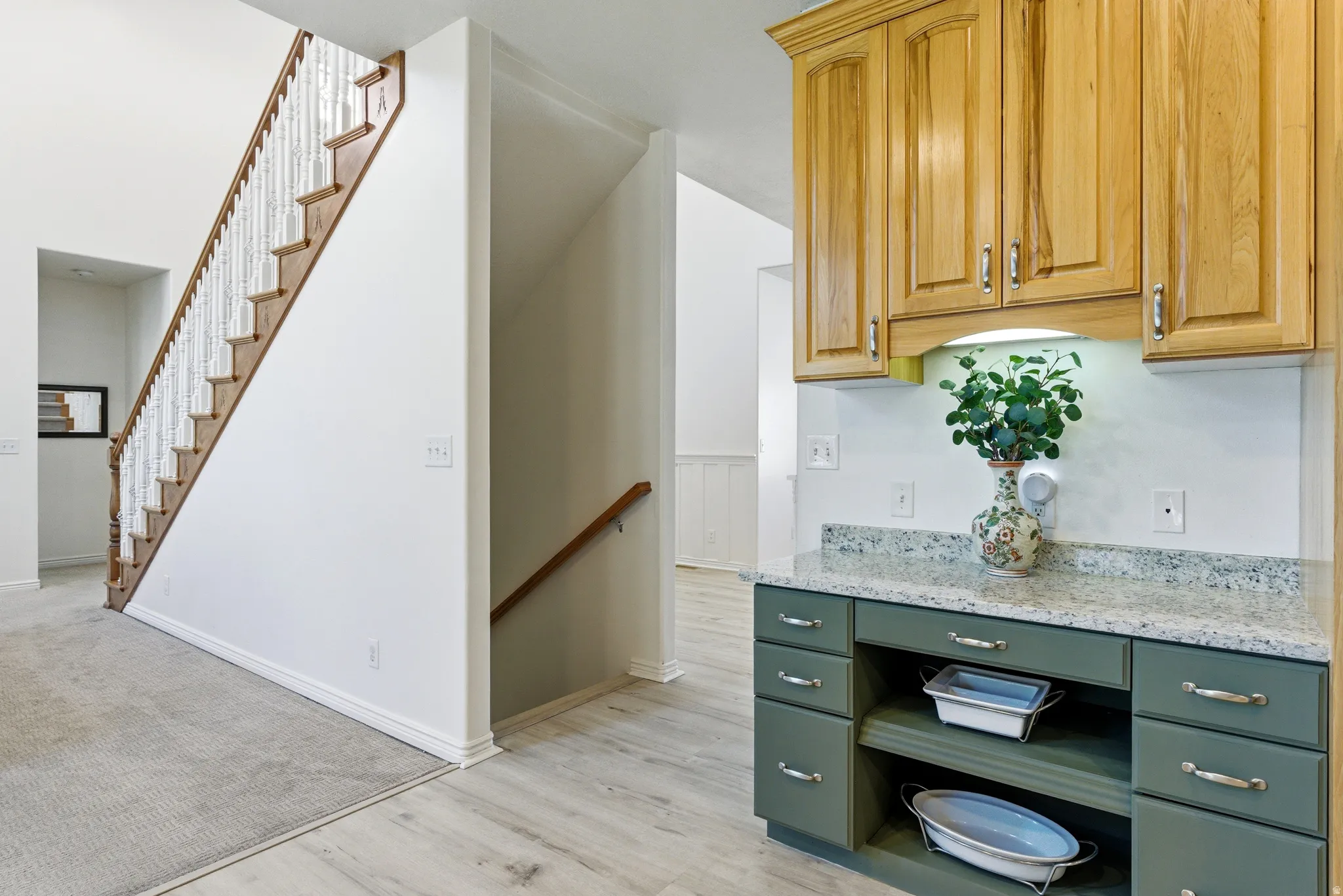 Staircase with wood-finish treads and white balusters