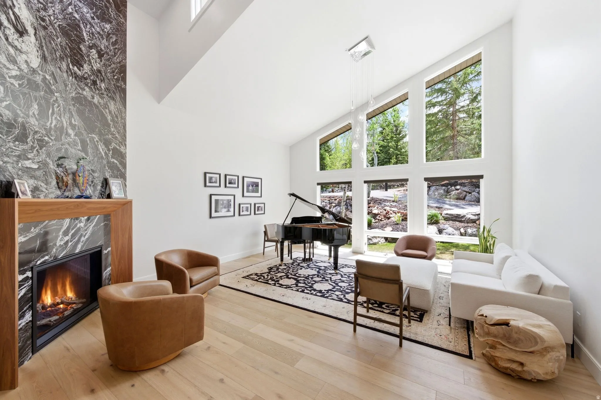 Living area featuring a floor-to-ceiling fireplace with a dark stone surround and wood mantel
