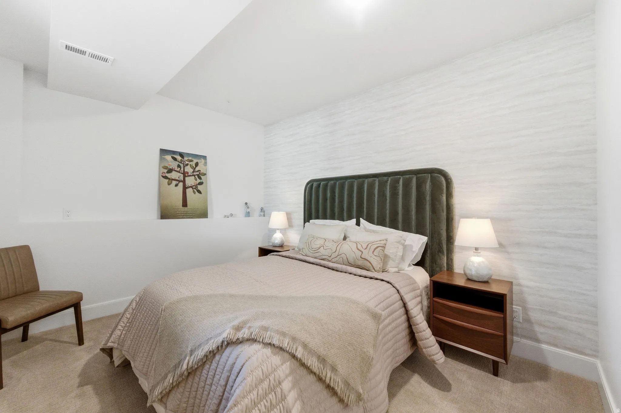 Carpeted bedroom featuring a textured accent wall, recessed lighting, and a built-in wall niche