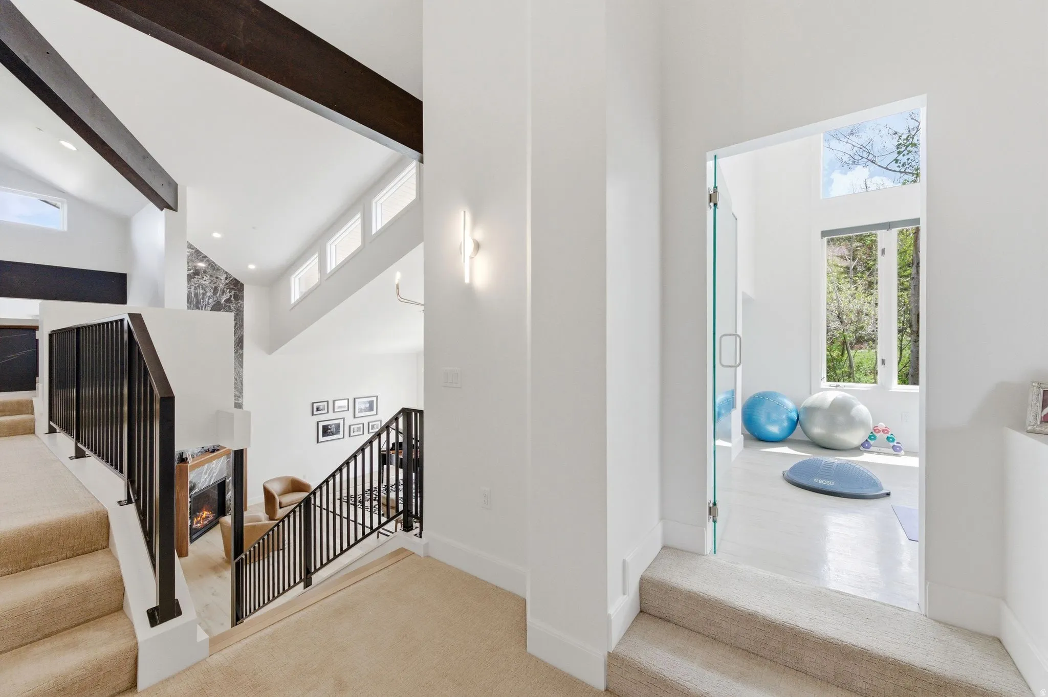 Upper level landing featuring carpeted stairs and a glass entry door