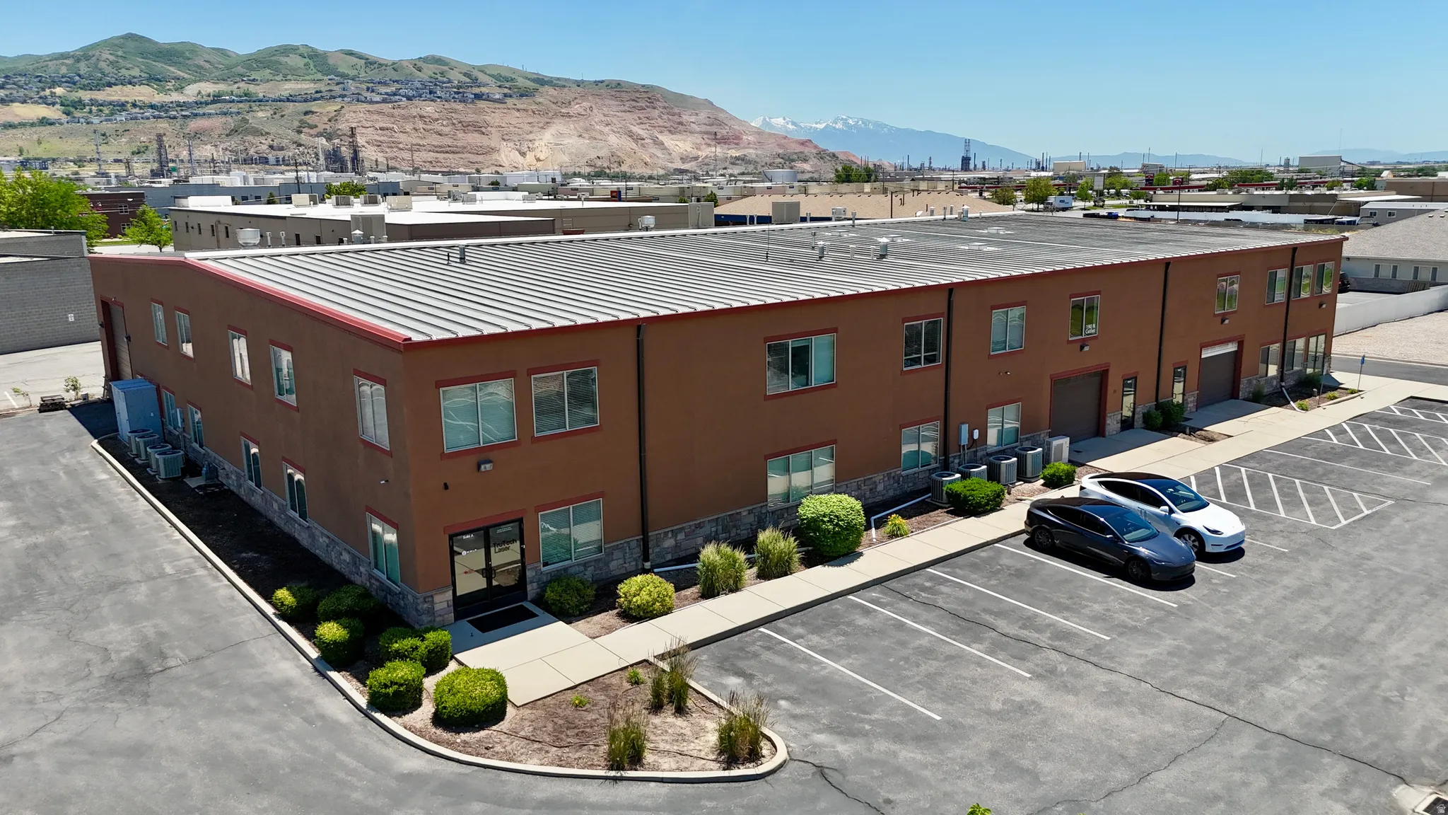 Two-story commercial building featuring a stucco exterior with stone veneer accents