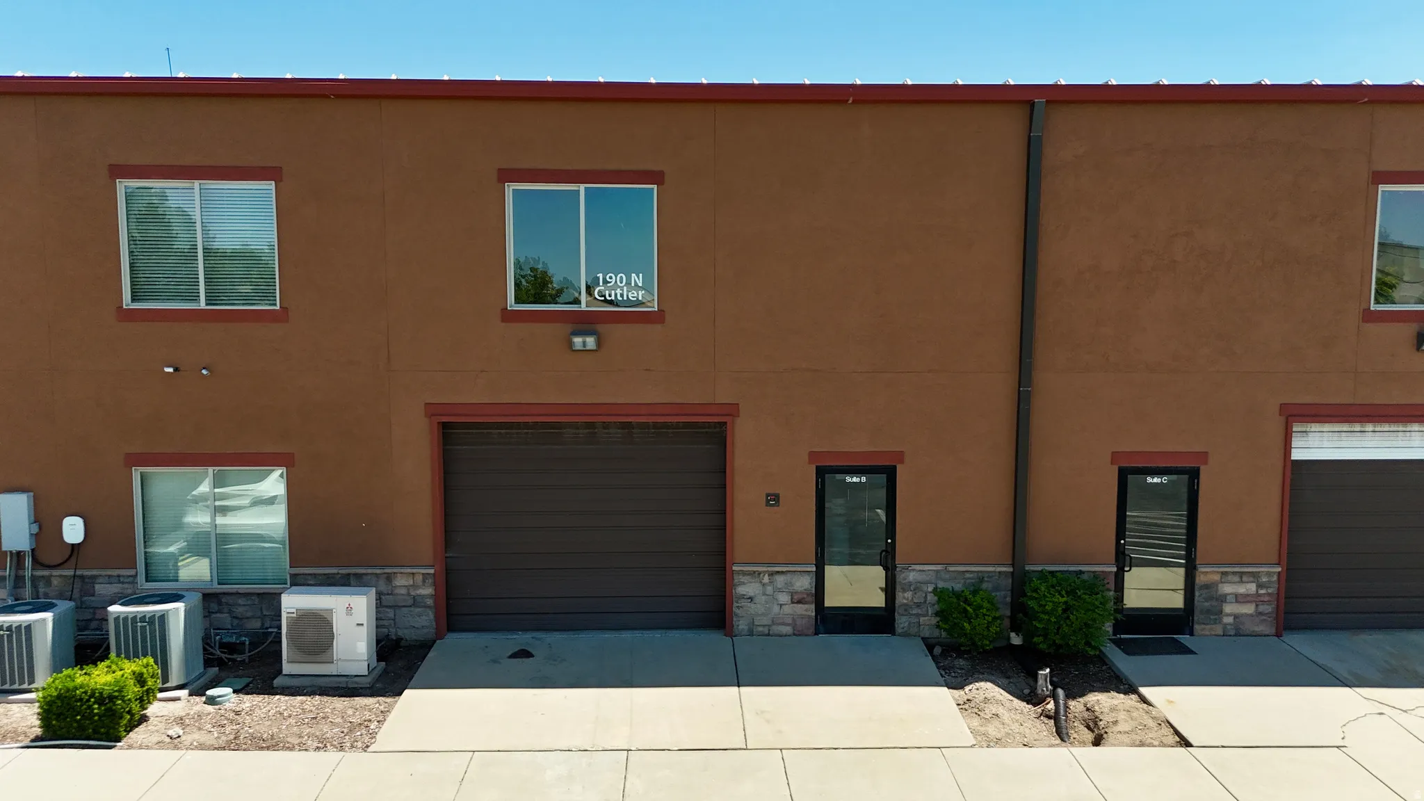 Brown stucco exterior with stone veneer accents