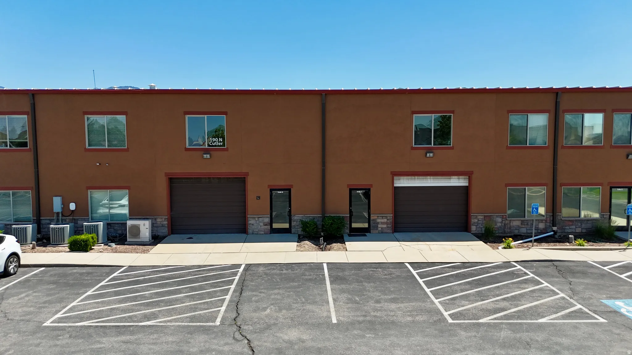 Two-story commercial building featuring stucco siding and a stone-finish facade