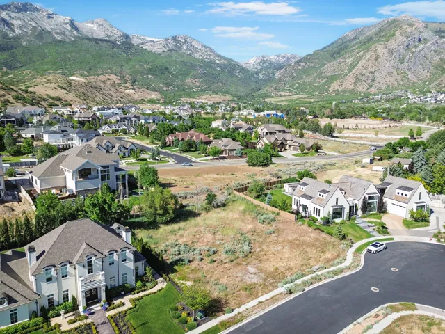 Expansive lot featuring mature trees and mountain scenery