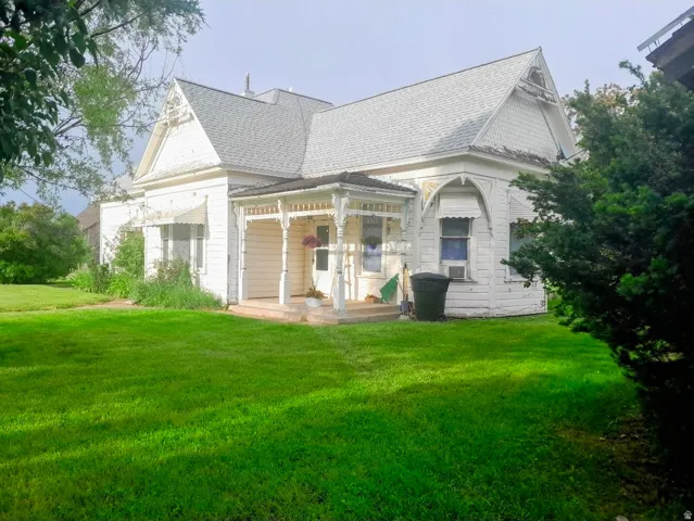 Classic white clapboard siding with decorative gables
