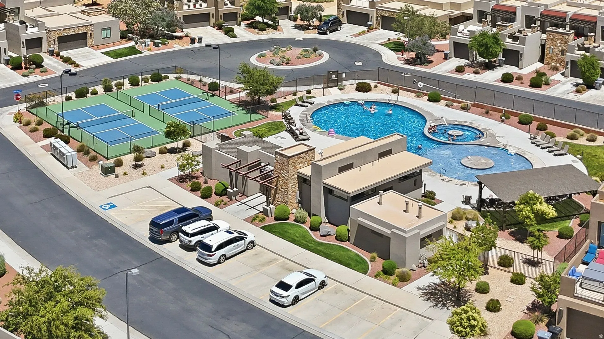 Multi-tiered swimming pool, integrated spa, and sport courts