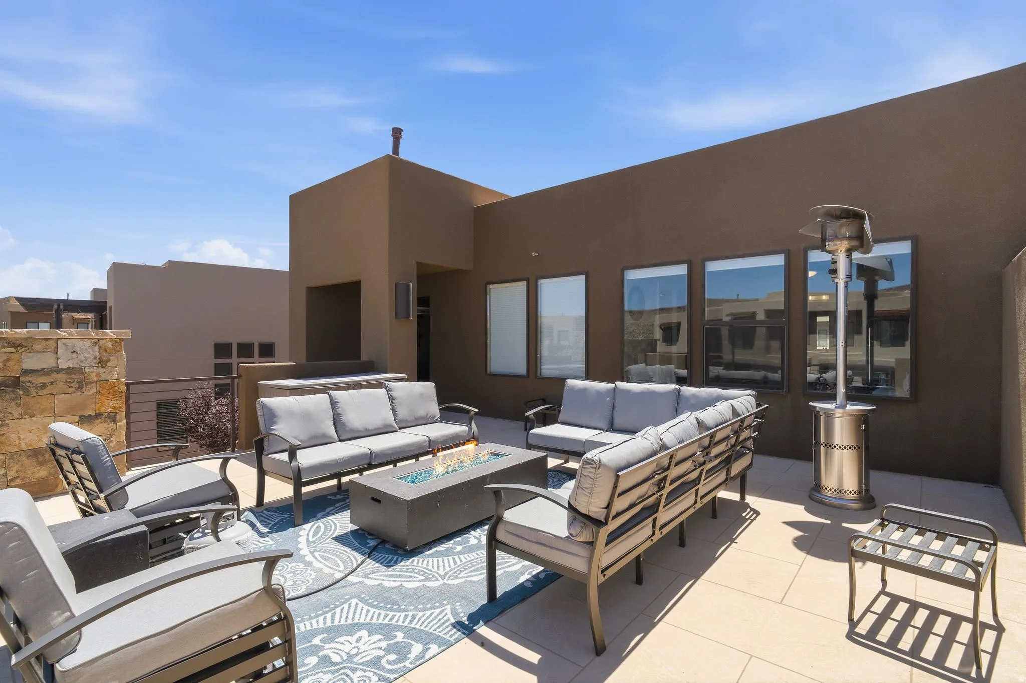 Expansive rooftop patio, fire pit, and golf course views