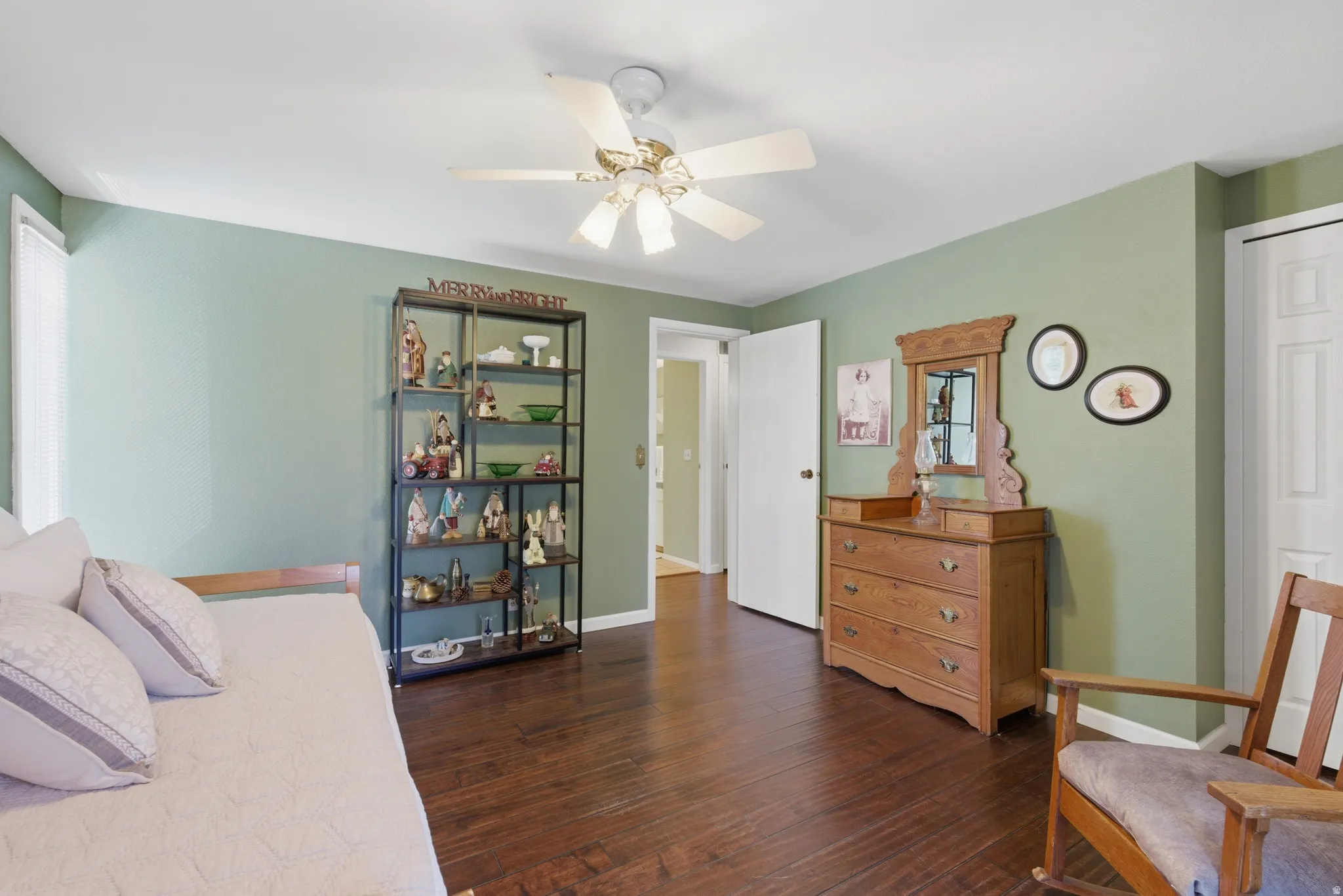 Spacious room featuring wood flooring and a ceiling fan