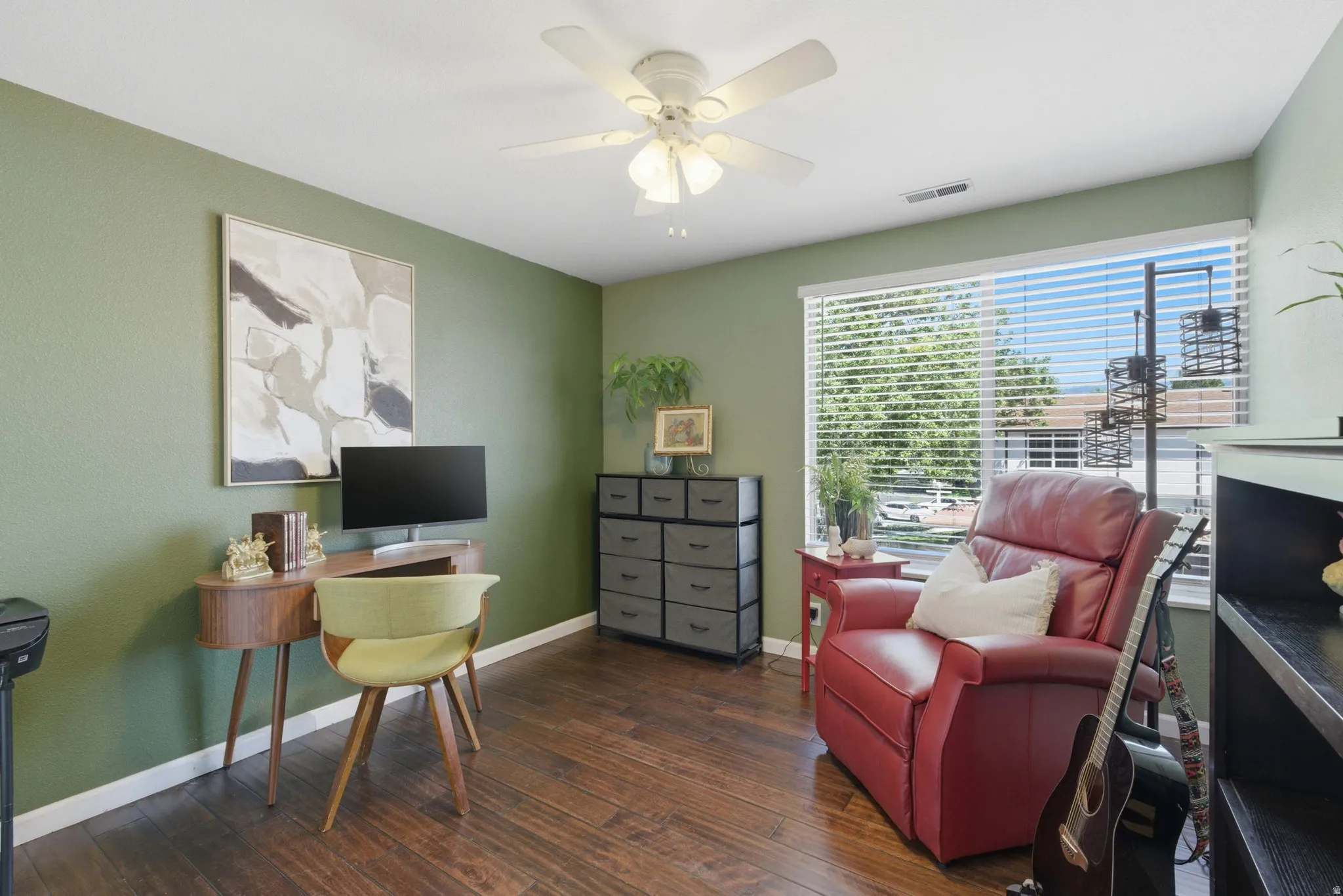 Bedroom/Office featuring wood-finish flooring, a ceiling fan, and a wide window with horizontal blinds