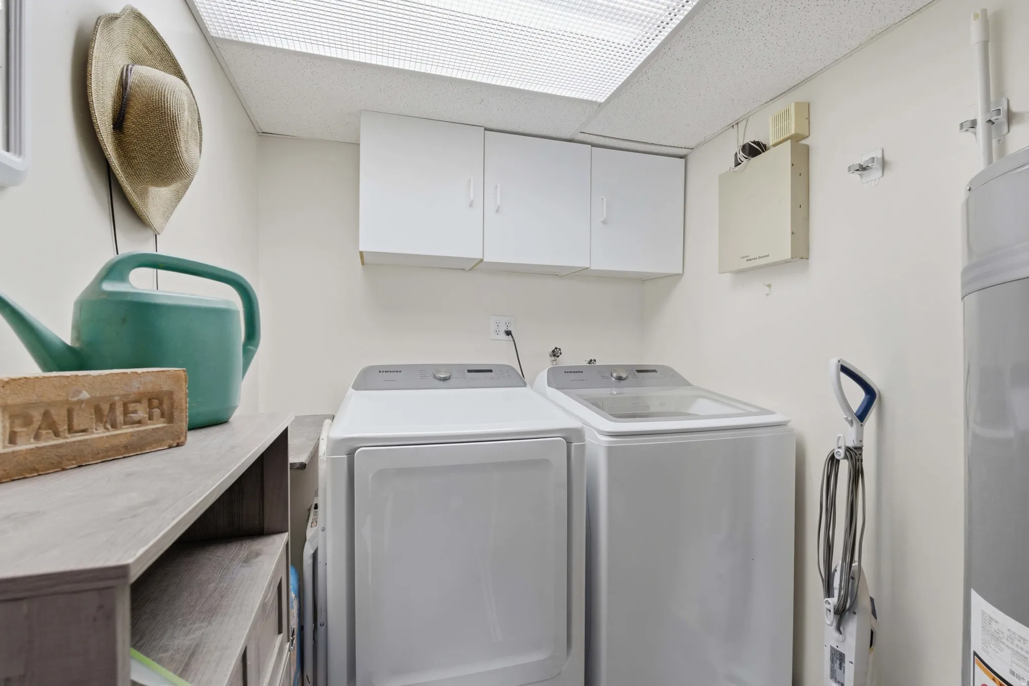 Dedicated laundry area featuring white upper cabinetry