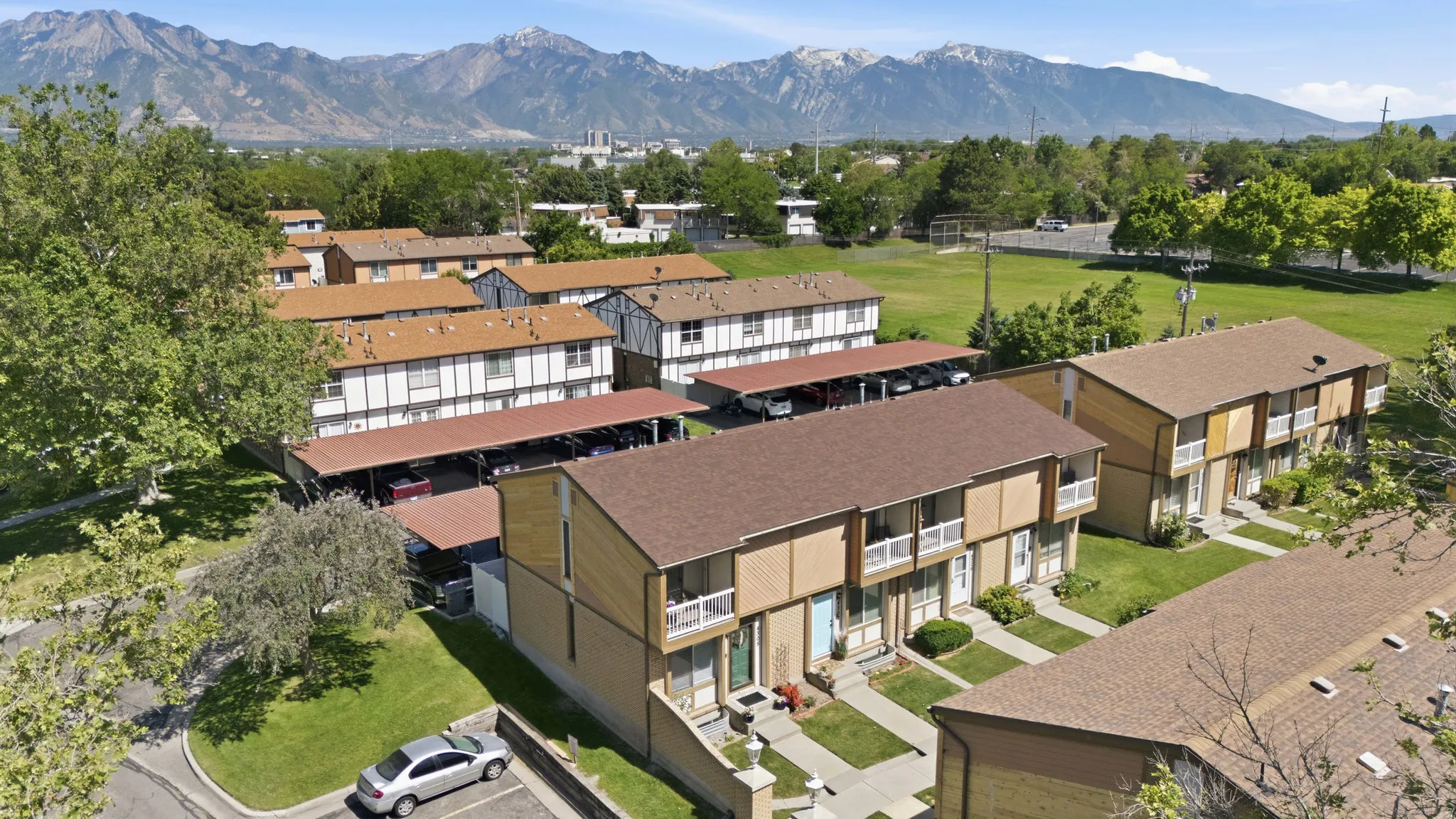 Townhome complex featuring covered parking structures and individual front entrances