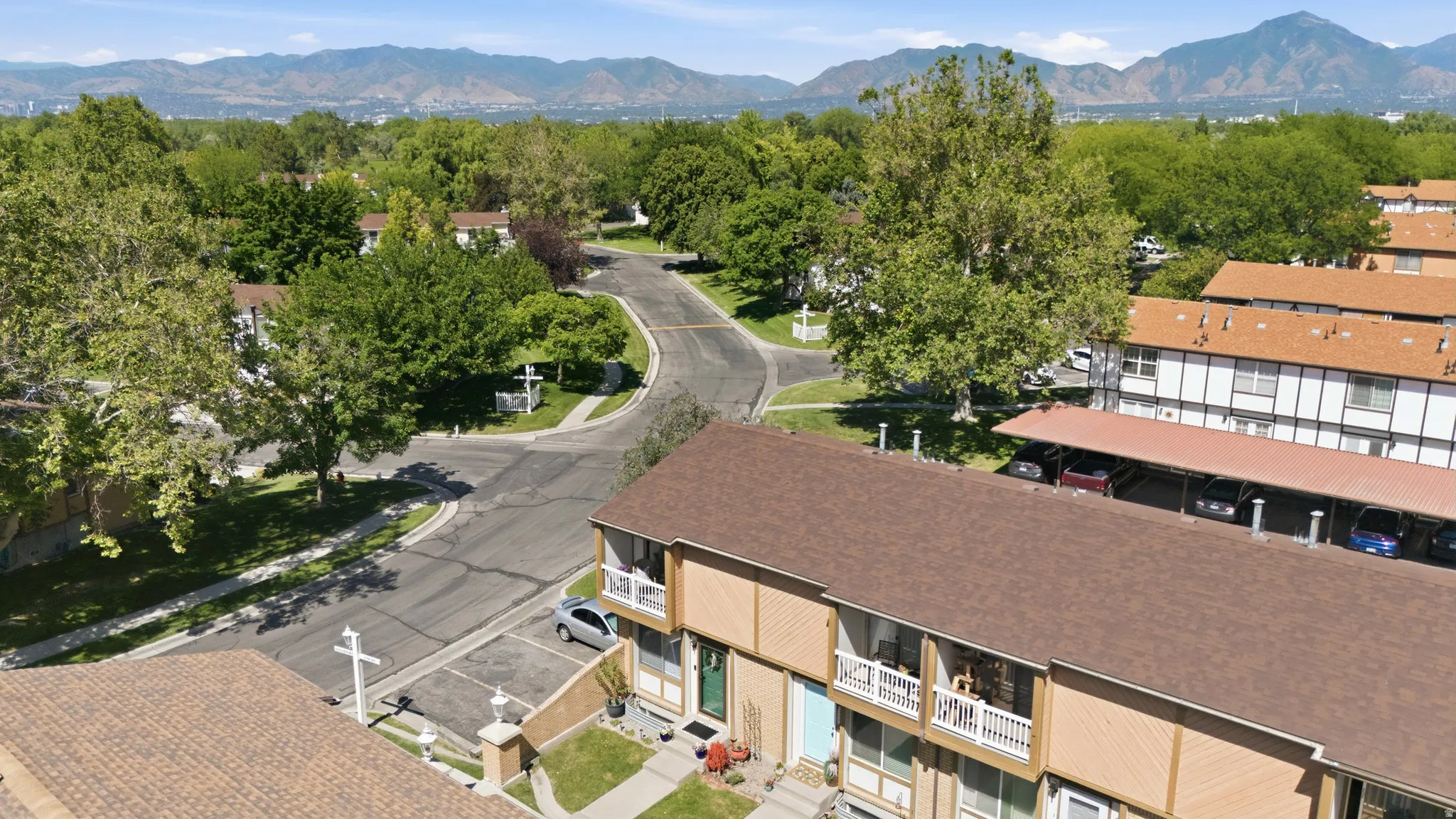 Townhome community featuring mature trees, paved streets, and mountain scenery