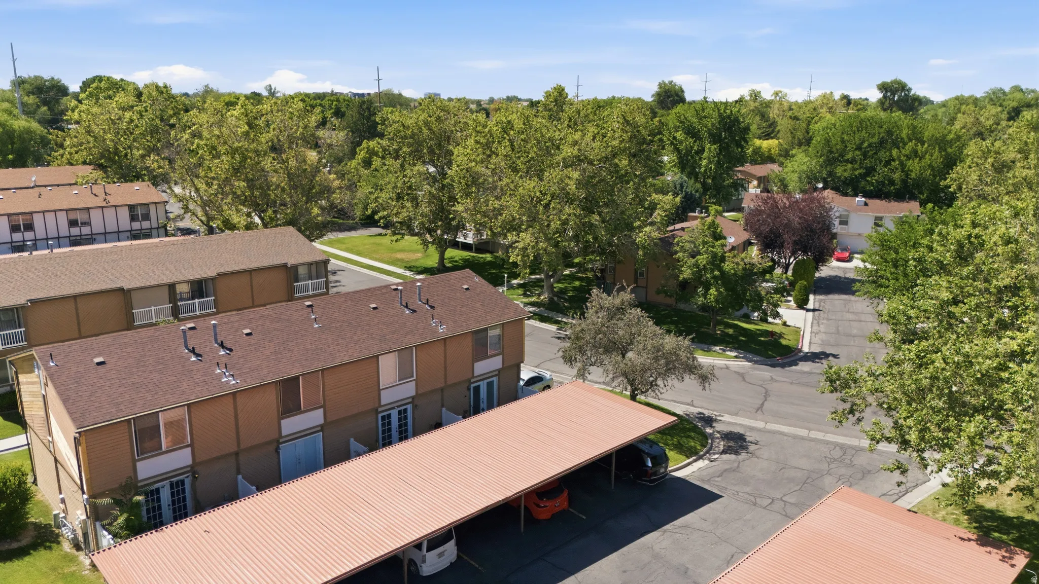 Multi-unit residential structures featuring brown roofs and light-colored siding