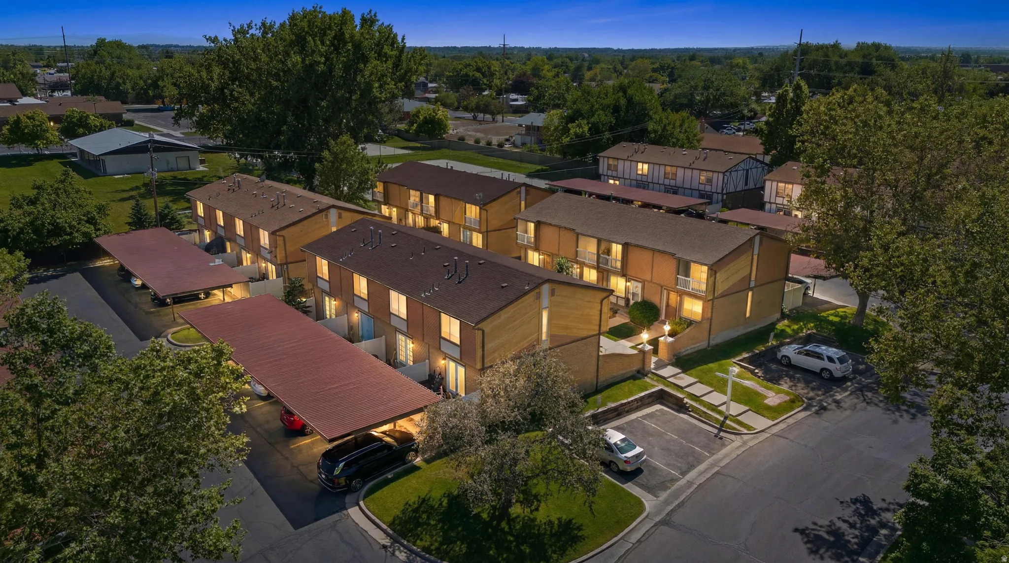 Multi-story residential buildings featuring covered parking structures and individual balconies