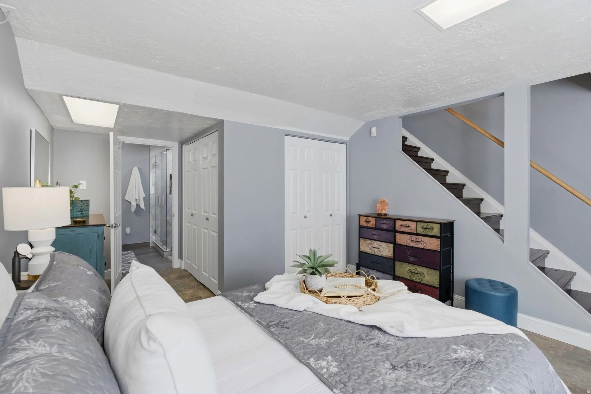 Spacious primary bedroom featuring neutral wall tones, recessed lighting, and durable tile flooring