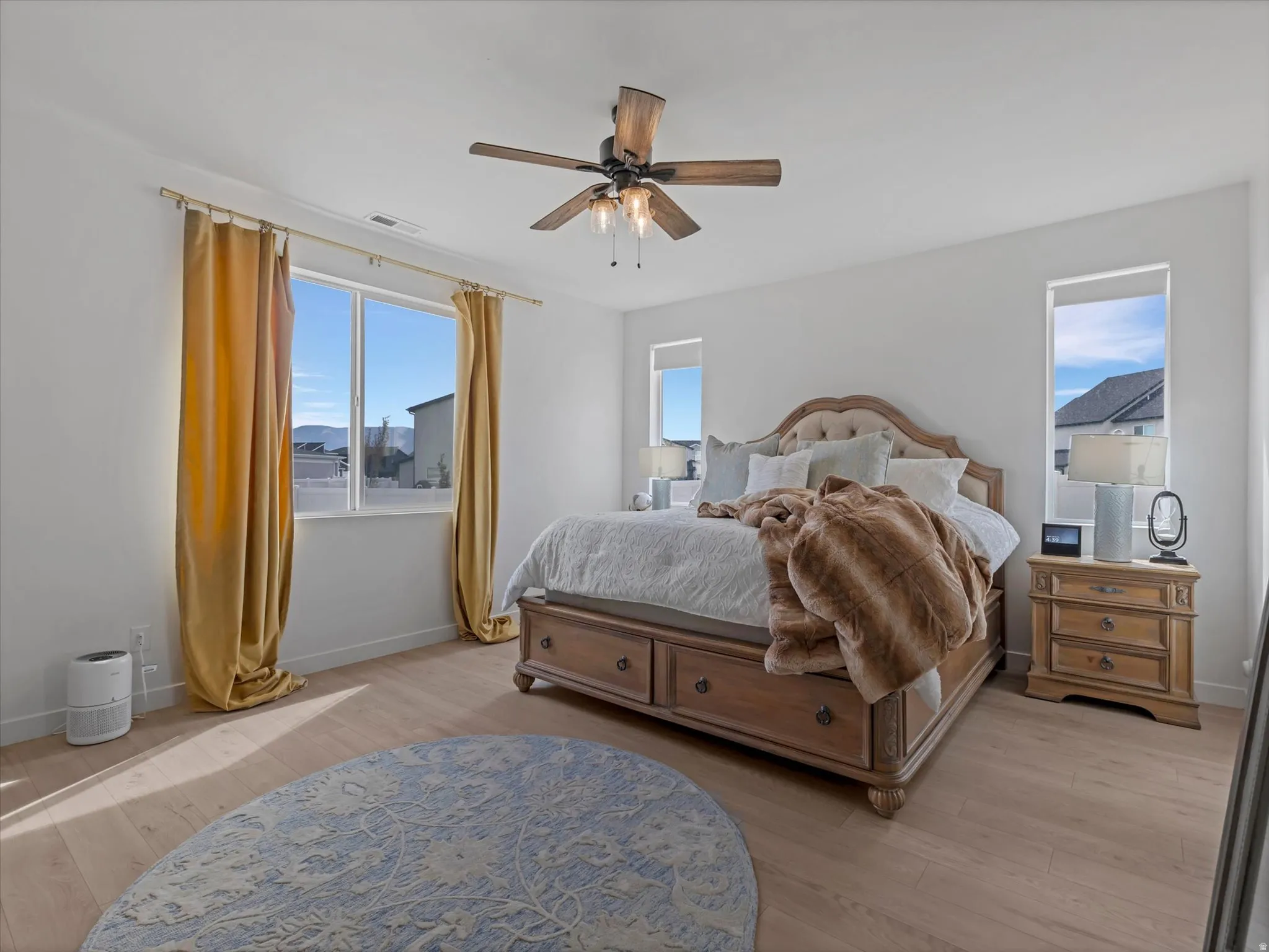 Light wood-finish flooring complements the neutral wall tones
