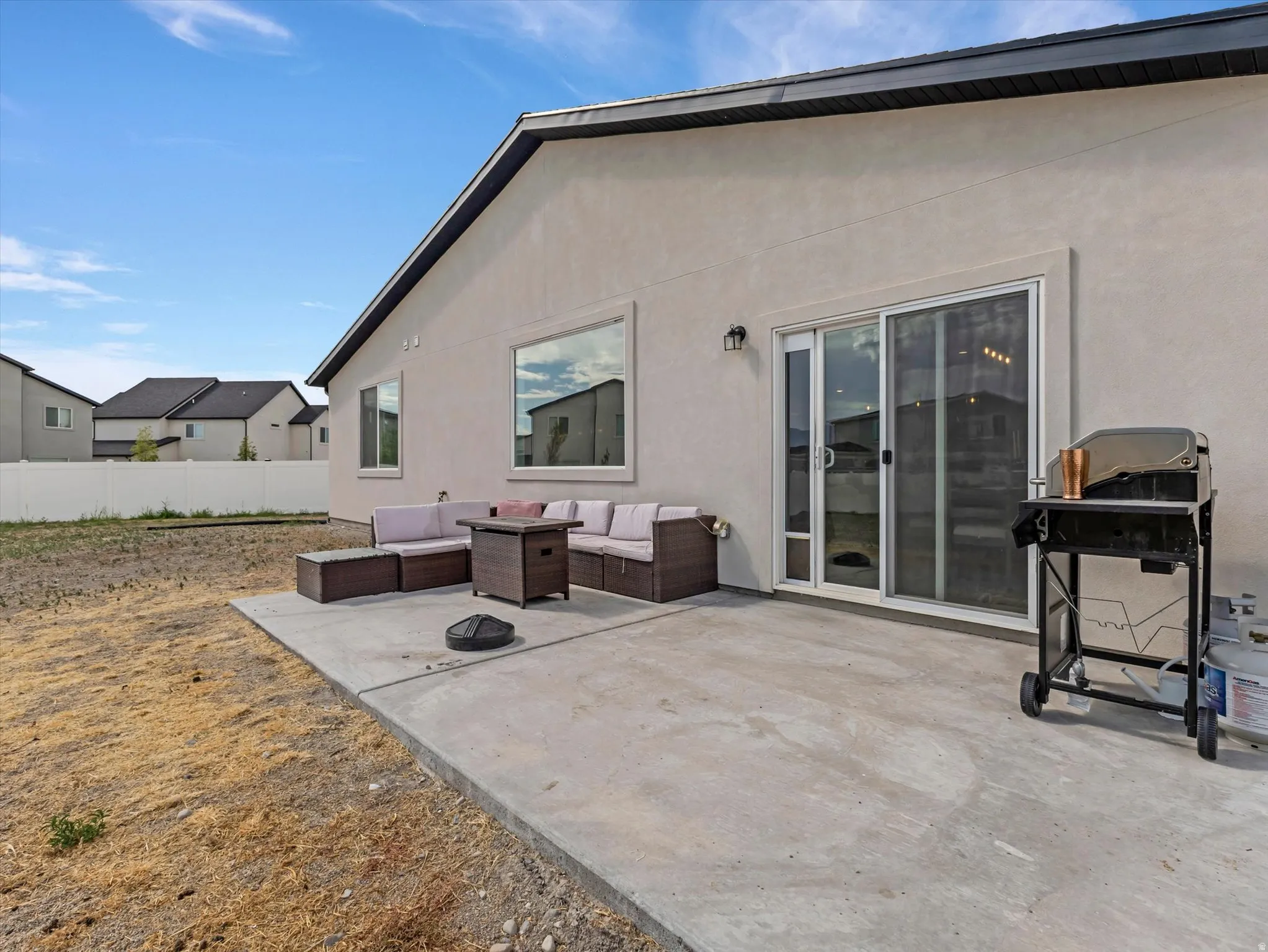 Rear exterior concrete patio with sliding glass door access