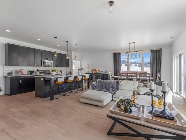 Open-concept living space with light wood-finish flooring