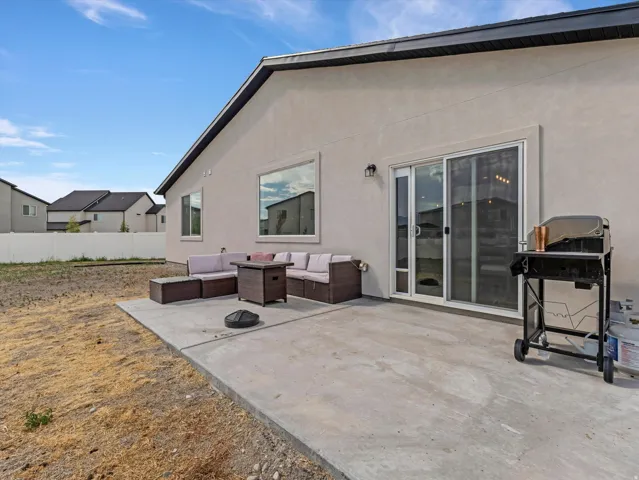 Rear exterior concrete patio with sliding glass door access