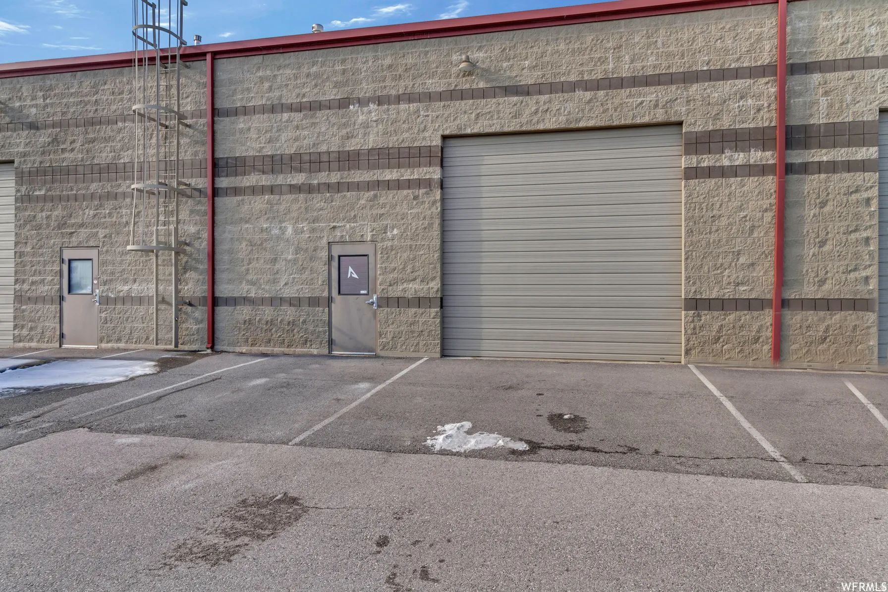 Industrial building with stone block facade and accent banding