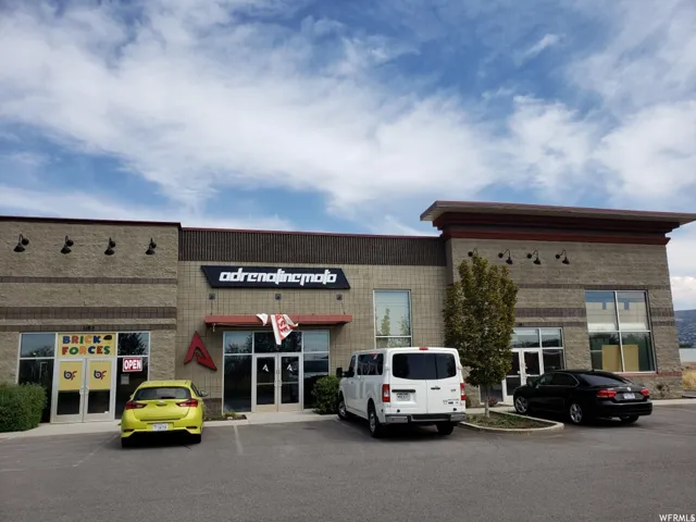 Commercial building featuring a brick facade with dark accent banding