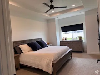 Tray ceiling with integrated lighting, recessed lighting, and a ceiling fan