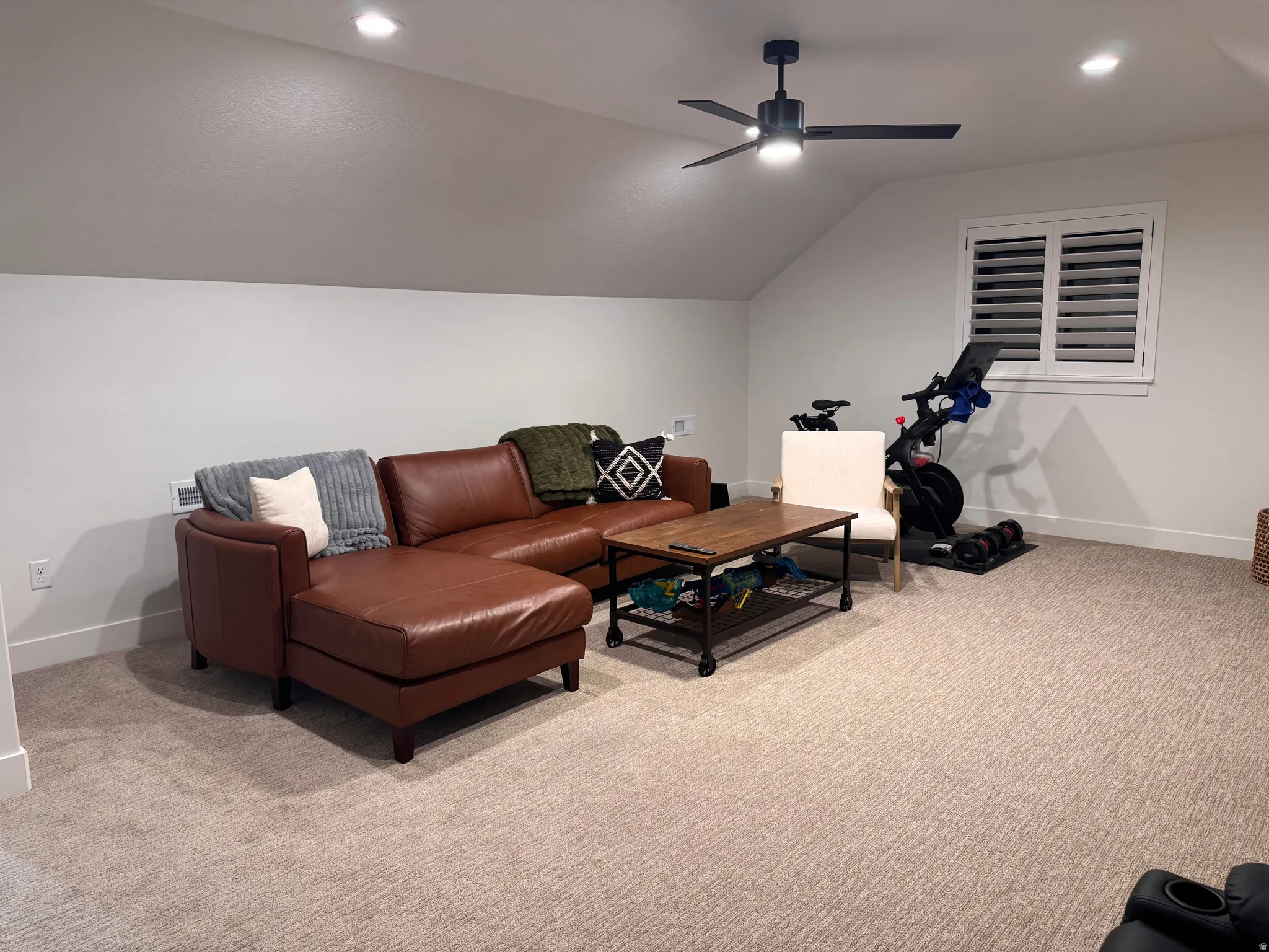 Carpeted bonus room featuring a sloped ceiling with recessed lighting and a ceiling fan