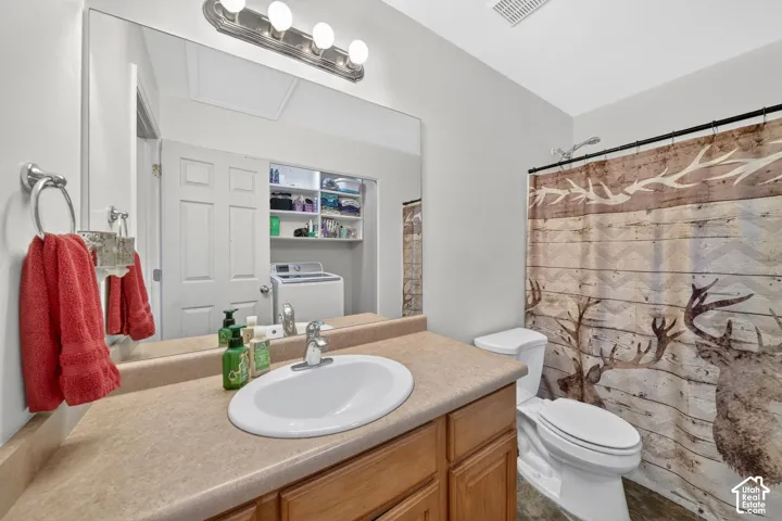 Full vanity with an integrated sink, laminate countertop, and wood-finish cabinetry