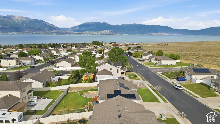Aerial perspective of a residential neighborhood featuring single-family homes with pitched roofs